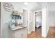 Hallway with a coffee bar, sink, and view into a bedroom with ocean decor and coastal style at 6001 N Ocean Blvd. # 342, North Myrtle Beach, SC 29582