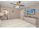 Charming bedroom featuring ceiling fan, TV, full dresser, and an ensuite bathroom at 6001-8026 South Kings Hwy., Myrtle Beach, SC 29575