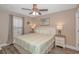 Cozy bedroom with a comfortable king-size bed, ceiling fan, and two bedside tables with lamps at 6001-8026 South Kings Hwy., Myrtle Beach, SC 29575