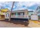 Charming home featuring a welcoming front porch and a brightly colored front door at 6001-8026 South Kings Hwy., Myrtle Beach, SC 29575
