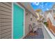 Relax on this front porch featuring a turquoise-painted door and two chairs for seating at 6001-8026 South Kings Hwy., Myrtle Beach, SC 29575