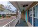 Quaint front porch with beautiful view, white railing, and a unique turquoise front door at 6001-8026 South Kings Hwy., Myrtle Beach, SC 29575