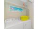 Functional laundry room with washer, dryer, storage shelves, and wall decor at 6001-8026 South Kings Hwy., Myrtle Beach, SC 29575
