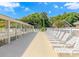 Exterior of a pool deck surrounded by lush landscaping and plenty of seating, providing a relaxing retreat at 6001-8026 South Kings Hwy., Myrtle Beach, SC 29575