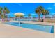 Tranquil pool area with mushroom fountains, lounge chairs, and palm trees, providing a serene and inviting atmosphere at 6001-8026 South Kings Hwy., Myrtle Beach, SC 29575