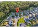 Aerial view of a charming neighborhood with lush green lawns, tree coverage, and various home styles at 6239 Chadderton Circle, Myrtle Beach, SC 29579