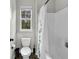 Clean bathroom featuring a bathtub and shower combination, toilet, and window with natural light at 6239 Chadderton Circle, Myrtle Beach, SC 29579