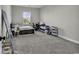 Bright bedroom with neutral carpeting, a bed and a desk, providing a comfortable and functional space at 6239 Chadderton Circle, Myrtle Beach, SC 29579
