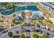 Aerial view of community amenities that include: pool, lake with fountain, playground, parking lot, and clubhouse at 6239 Chadderton Circle, Myrtle Beach, SC 29579