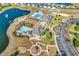 Aerial view of community amenities that include: pool, lake with fountain, playground, parking lot, and clubhouse at 6239 Chadderton Circle, Myrtle Beach, SC 29579