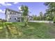 Charming two-story home with a well-maintained lawn, white fence, and views of the surrounding lush trees at 6239 Chadderton Circle, Myrtle Beach, SC 29579
