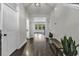 Inviting hallway with hardwood floors, neutral paint, and views into dining and living areas at 6239 Chadderton Circle, Myrtle Beach, SC 29579