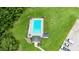 Aerial view of the community pool, sun loungers, and pool house surrounded by lush green grass at 6544 Amberwood Ct., Myrtle Beach, SC 29588