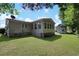 Well-kept backyard featuring a sunroom, shed, and lush lawn, with easy access from the home at 6544 Amberwood Ct., Myrtle Beach, SC 29588
