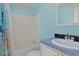 Bright bathroom features a shower-tub combo with blue walls and a seashell shower curtain at 6544 Amberwood Ct., Myrtle Beach, SC 29588