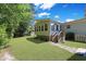Exterior view of a sunroom with a stairway, showcasing a well-maintained backyard at 6544 Amberwood Ct., Myrtle Beach, SC 29588