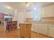 Well-lit kitchen with white cabinetry, a functional island, and eat-in bar seating at 6544 Amberwood Ct., Myrtle Beach, SC 29588