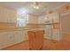 Charming kitchen features white cabinets, modern appliances, and a functional mobile kitchen island at 6544 Amberwood Ct., Myrtle Beach, SC 29588