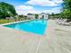 Community pool with clear blue water surrounded by lounge chairs, and a secure fenced enclosure at 6544 Amberwood Ct., Myrtle Beach, SC 29588