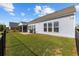 Well-maintained backyard featuring a manicured lawn, patio, and glimpses of a screened-in porch at 6591 Cagliari Court, Myrtle Beach, SC 29572