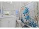 Bathroom with white vanity, decorative shower curtain, and coastal-themed decor at 6591 Cagliari Court, Myrtle Beach, SC 29572