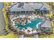 Breathtaking aerial view of a community pool area with lush landscaping and ample seating at 6591 Cagliari Court, Myrtle Beach, SC 29572