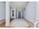 Covered front porch featuring a modern front door and brick accents at 6591 Cagliari Court, Myrtle Beach, SC 29572