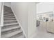 Hallway with stairs leading to an open concept kitchen and dining area at 6591 Cagliari Court, Myrtle Beach, SC 29572