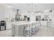 Modern kitchen with white cabinets, stainless steel appliances, and a large center island at 6591 Cagliari Court, Myrtle Beach, SC 29572