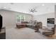Cozy living room with comfortable seating, ceiling fan, recessed lighting, and a large window at 6591 Cagliari Court, Myrtle Beach, SC 29572