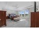Serene main bedroom featuring a tray ceiling, a large window with water view, and stylish furnishings at 6591 Cagliari Court, Myrtle Beach, SC 29572