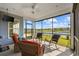 Relaxing screened-in porch with comfortable seating, ceiling fan, and serene lake views at 6591 Cagliari Court, Myrtle Beach, SC 29572