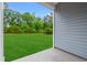 View of the spacious, green backyard framed by the home's siding and lush trees at 662 Wallace Dr., Little River, SC 29566