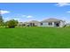Spacious backyard featuring lush green grass and a fence, perfect for outdoor activities at 662 Wallace Dr., Little River, SC 29566
