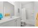 Bright bathroom featuring a tub/shower combo and vanity with grey tile floor at 662 Wallace Dr., Little River, SC 29566