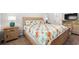 Comfortable bedroom featuring natural light, a bed with floral bedding, and matching nightstands at 662 Wallace Dr., Little River, SC 29566