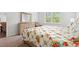 Bright bedroom featuring a dresser, comfortable bed, and a chair near the window at 662 Wallace Dr., Little River, SC 29566