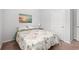 Bedroom with natural light, a bed with floral bedding, and soothing beach themed wall art at 662 Wallace Dr., Little River, SC 29566