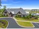 Exterior shot of the community clubhouse with stone accents and well manicured landscaping at 662 Wallace Dr., Little River, SC 29566