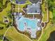 Aerial view of community pool with surrounding lounge chairs, cabanas, playground, and landscaping at 662 Wallace Dr., Little River, SC 29566