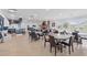Spacious community room with tables, chairs, fireplace, and kitchen bar area at 662 Wallace Dr., Little River, SC 29566