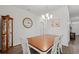 Bright dining room with wood table, white chairs, and decorative accents at 662 Wallace Dr., Little River, SC 29566