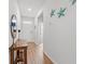 Bright entryway featuring wood floors, decorative accents, and a clear view to interior at 662 Wallace Dr., Little River, SC 29566