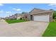 Inviting home exterior showcasing a well-maintained lawn and a two-car garage at 662 Wallace Dr., Little River, SC 29566