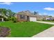 Well-kept home exterior features brick accents, a two-car garage, and lush green lawn at 662 Wallace Dr., Little River, SC 29566