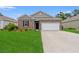 Charming brick home with a well-manicured lawn and a two-car garage at 662 Wallace Dr., Little River, SC 29566