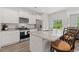 Bright kitchen features stainless steel appliances, granite countertops, and an island at 662 Wallace Dr., Little River, SC 29566