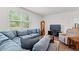 Spacious living room featuring a sectional, TV, and wooden grandfather clock at 662 Wallace Dr., Little River, SC 29566
