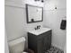 Clean and bright bathroom featuring gray vanity, black fixtures, and black-and-white patterned floor at 675 Liberty Church Rd., Loris, SC 29569