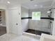 Modern bathroom boasts a sleek glass enclosed shower with gray tiling and a black accent stripe at 675 Liberty Church Rd., Loris, SC 29569